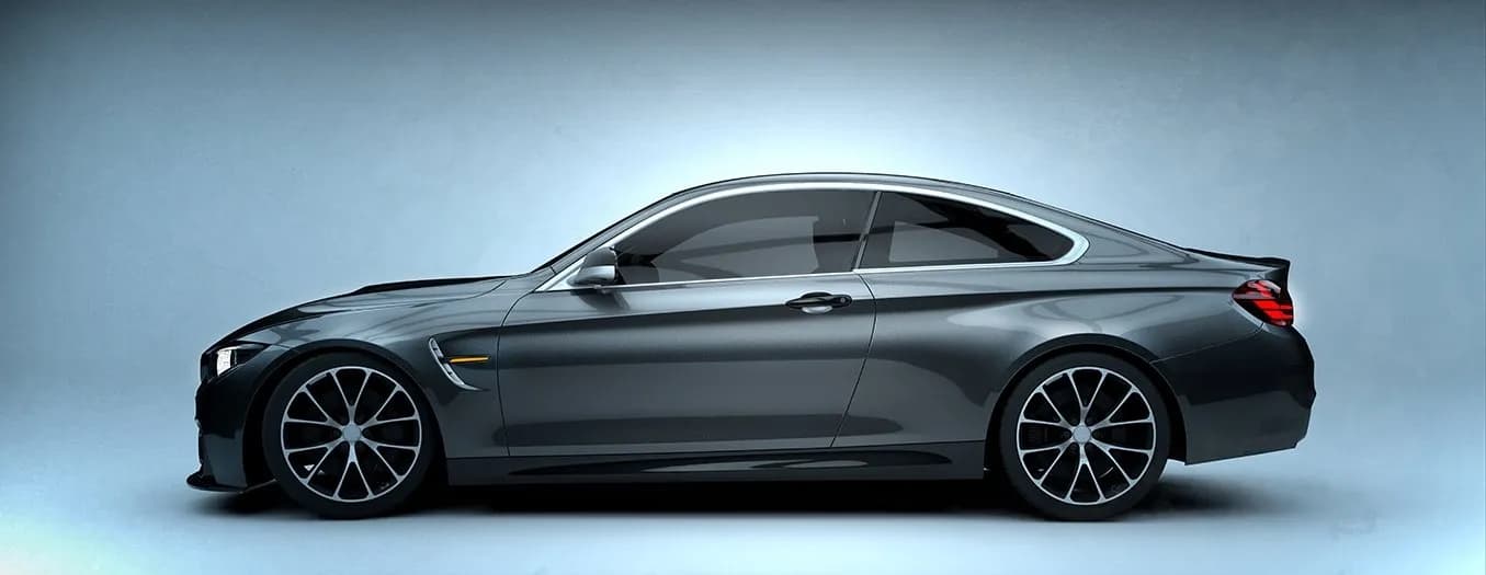 Medium window tint on a grey coupe, side view