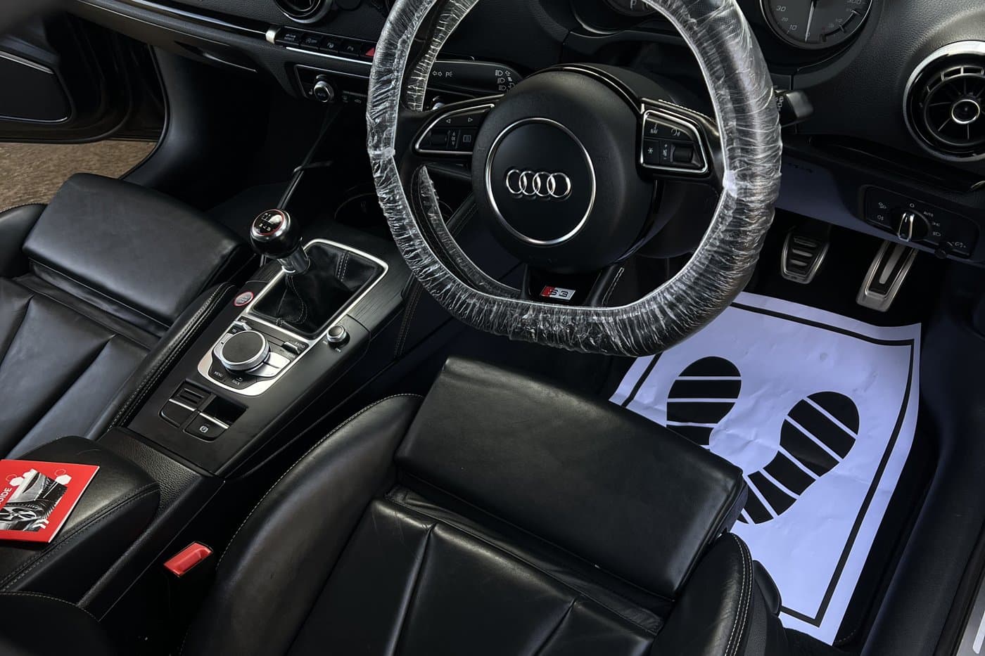 Car interior being detailed with protective covers on