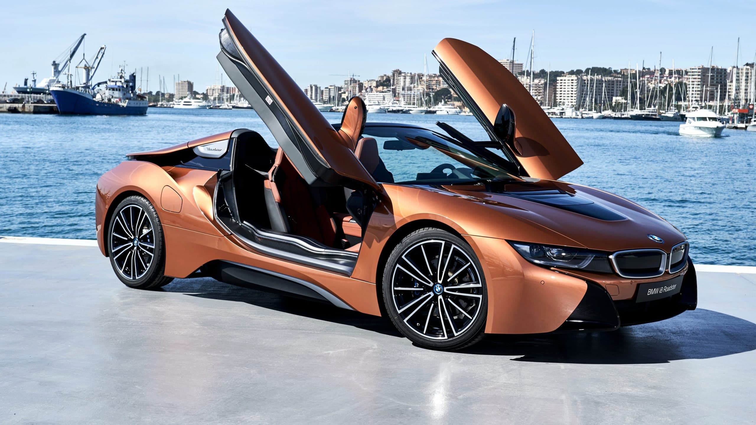 BMW i8 with its doors open by the harbour