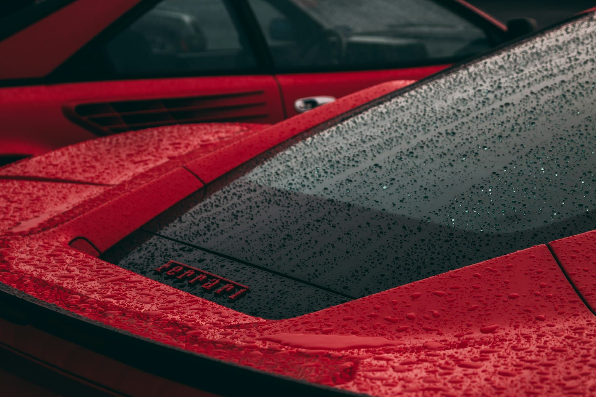 Raindrops on a red sports car