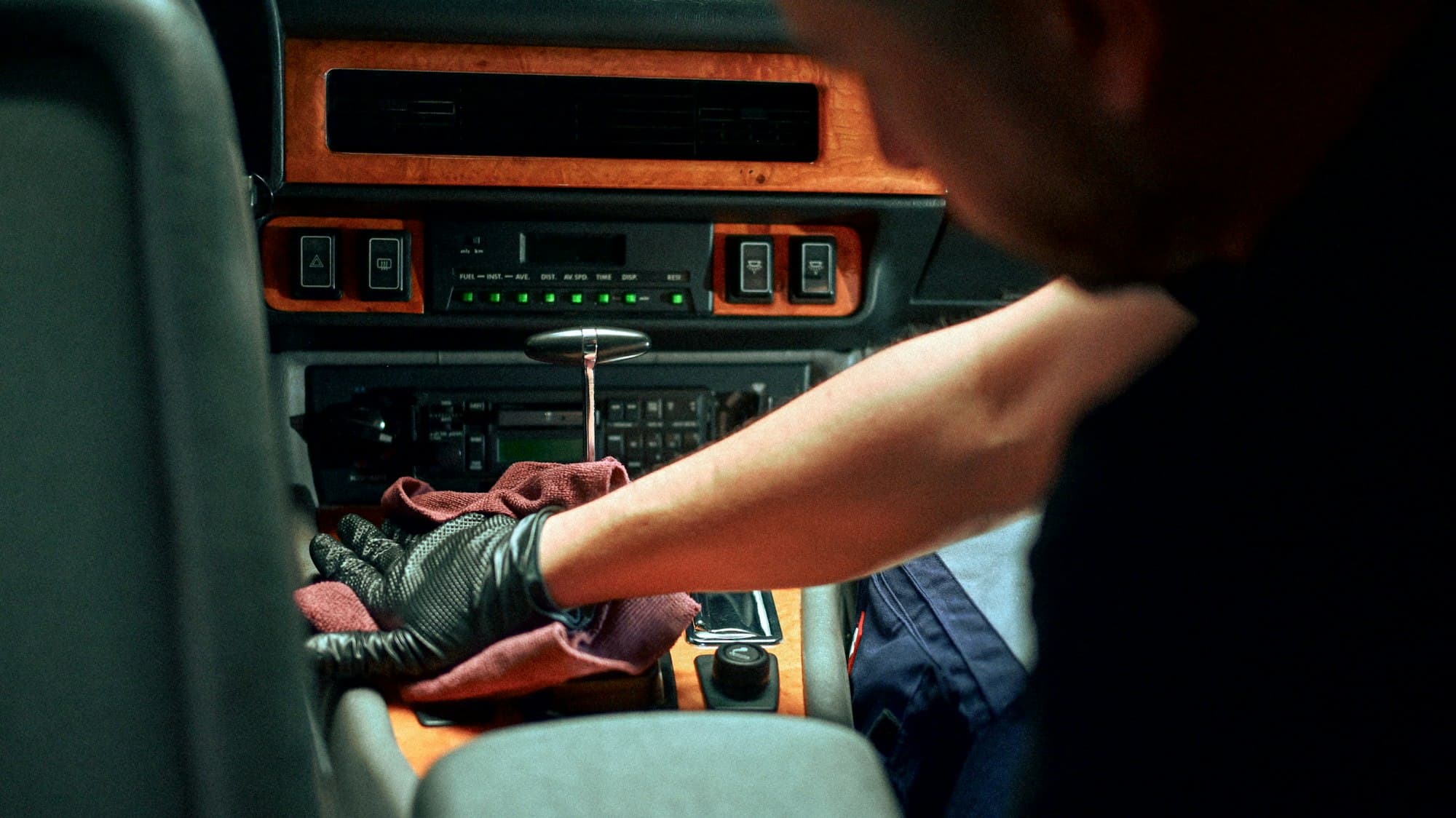 Car dashboard being cleaned by hand
