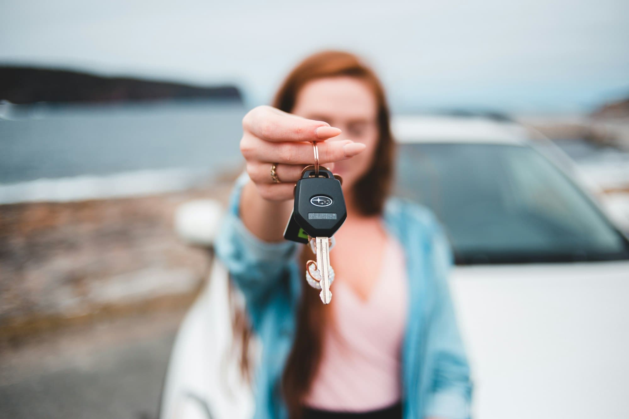 Woman holding up a car key