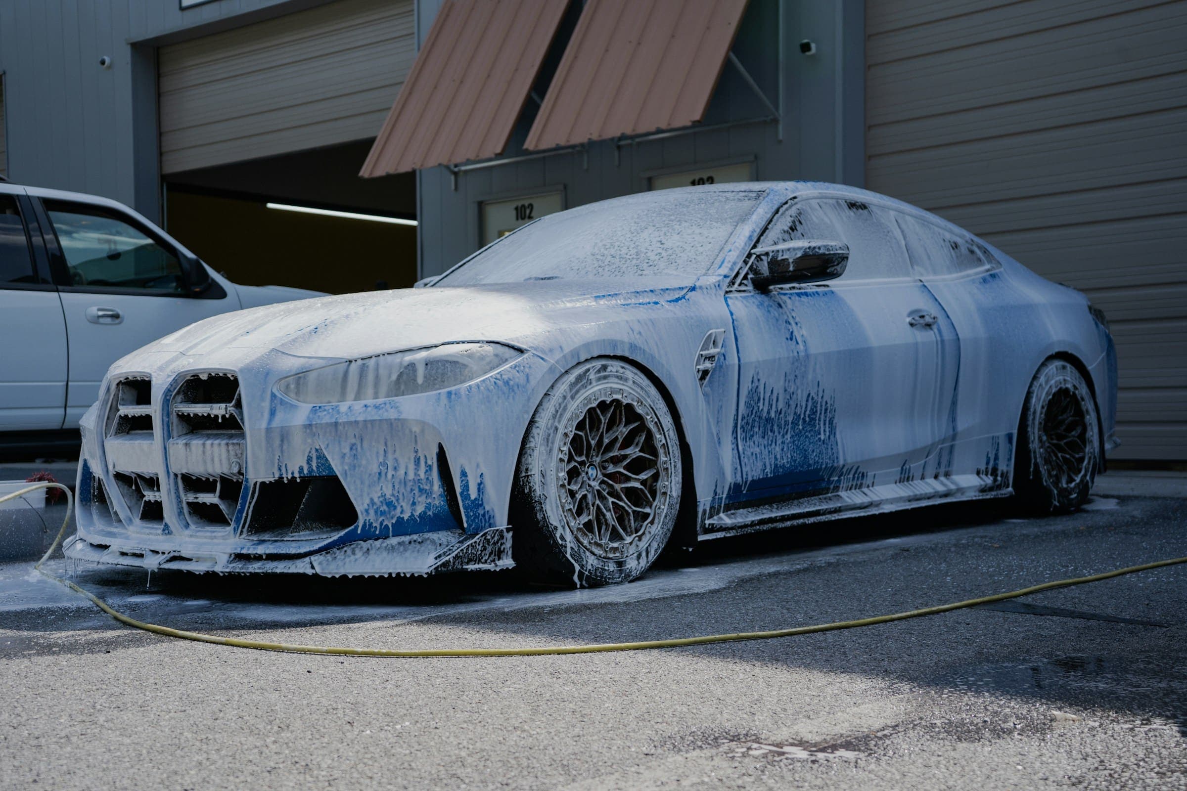 BMW covered in snow foam during a hand wash