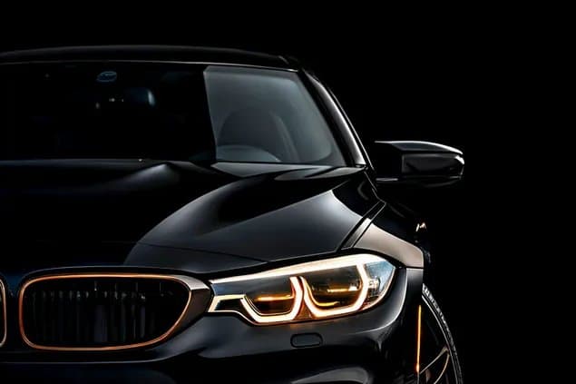 Front of a dark BMW at night