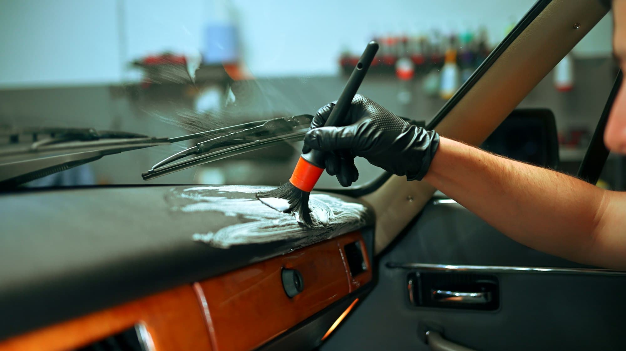 Detailer cleaning a car dashboard