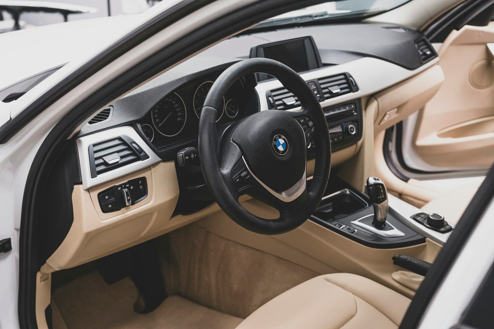 Clean car interior with beige seats and dashboard
