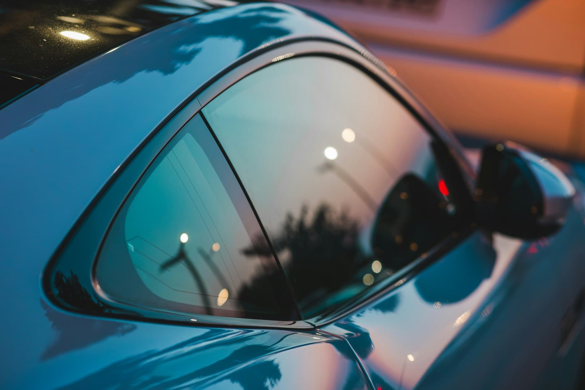 Close-up of a car side window and mirror