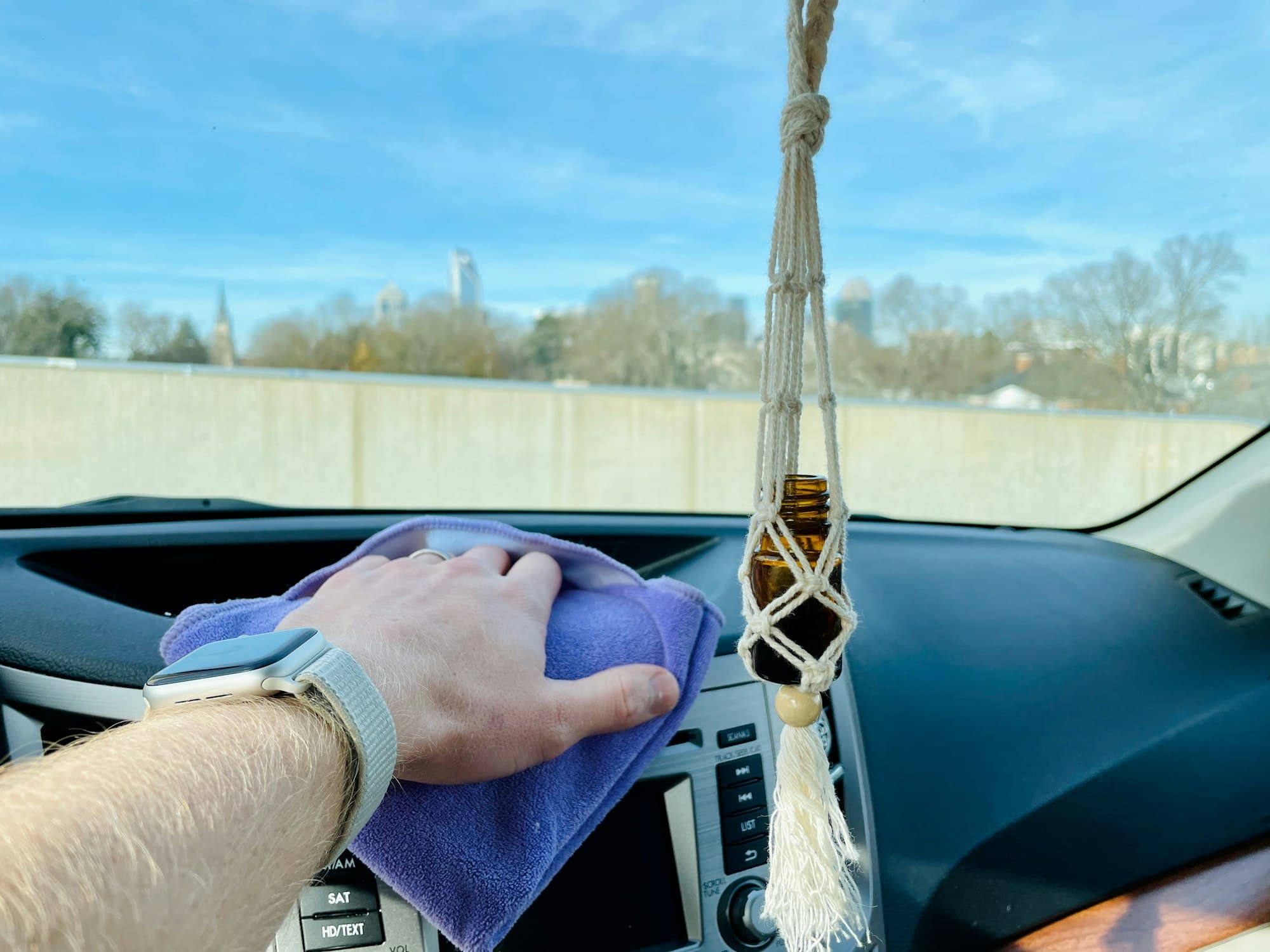 Car dashboard being wiped with a microfibre cloth