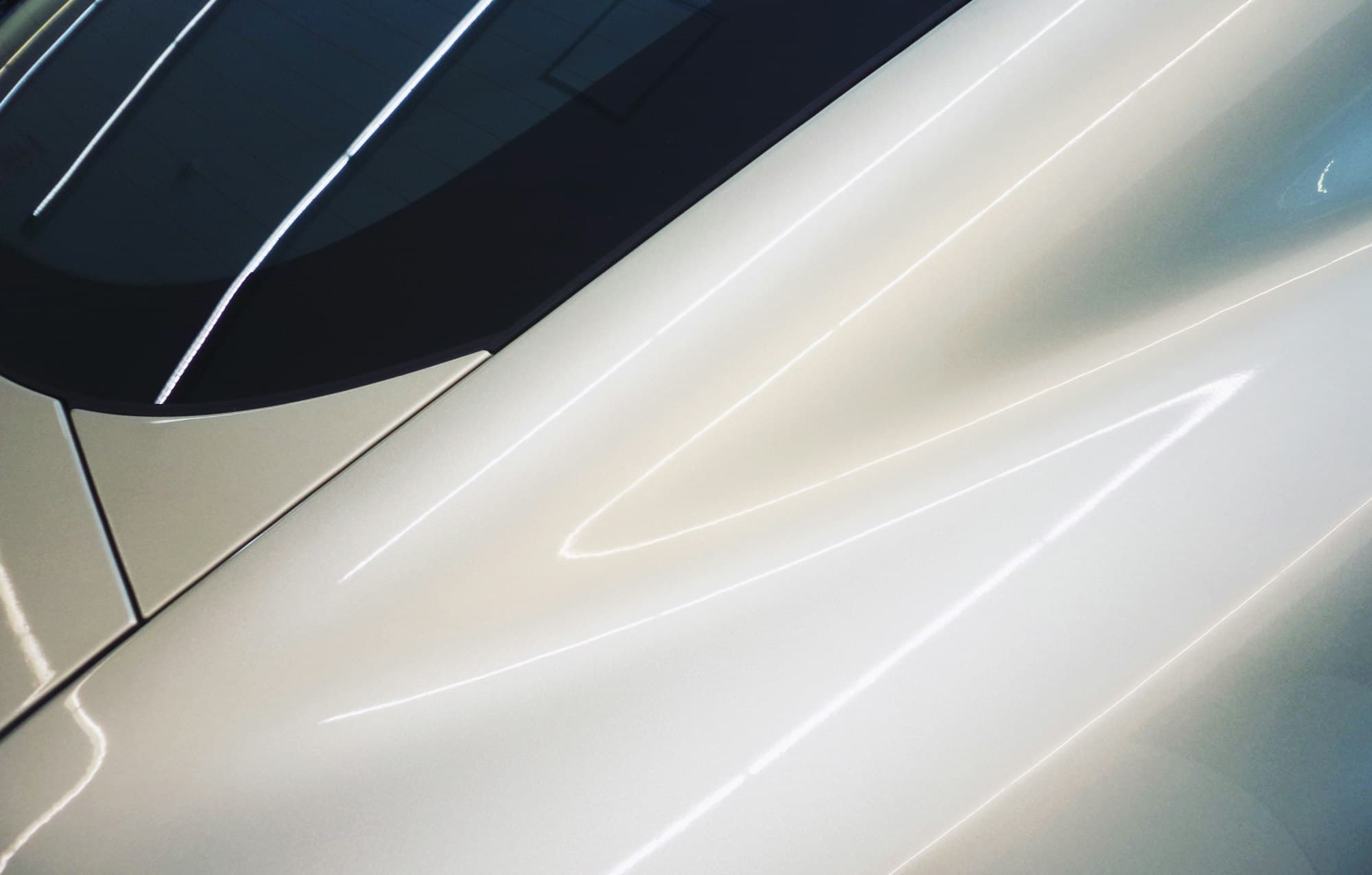 Close-up of glossy white car paint after polishing