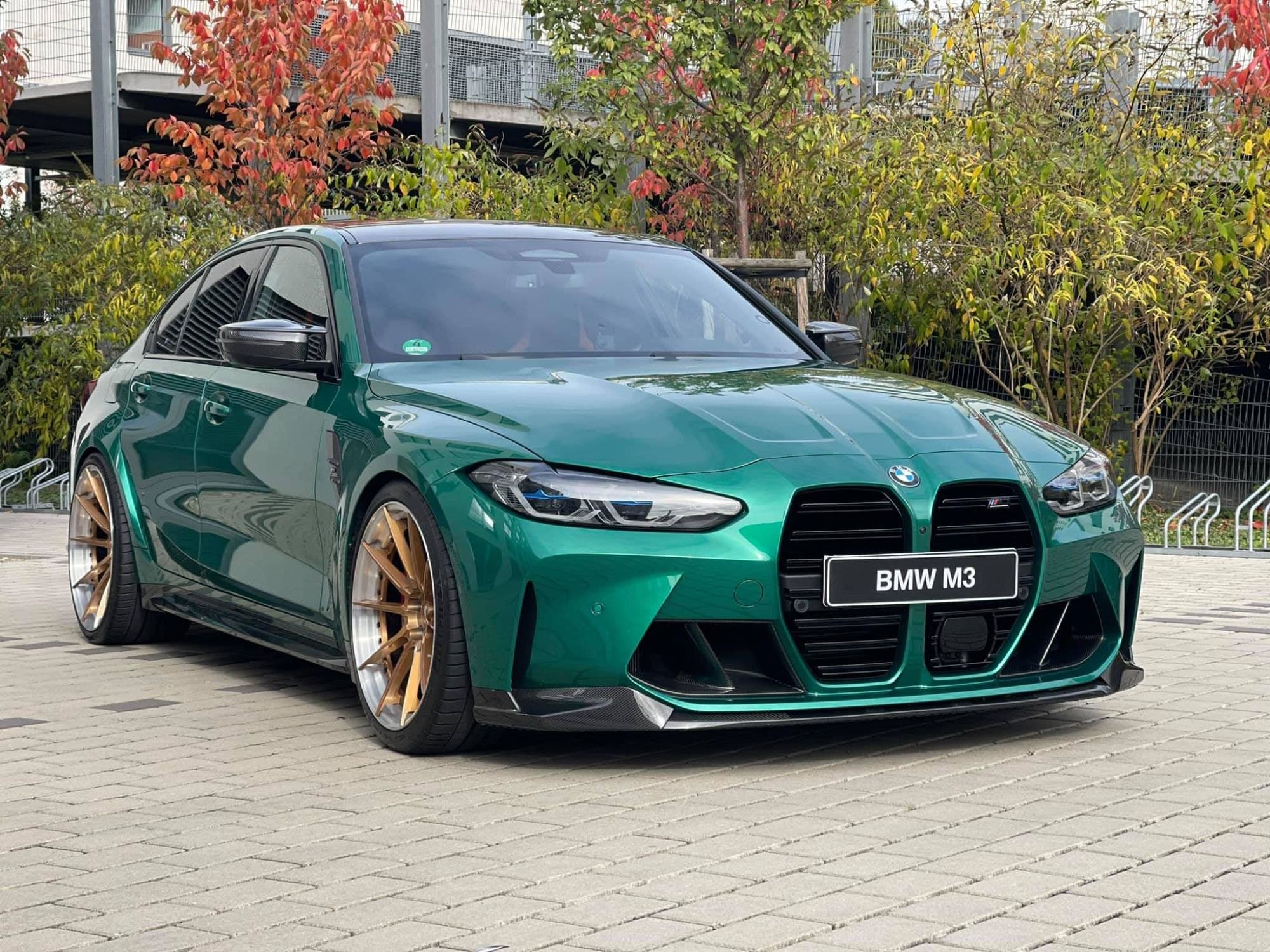 Green BMW M3 with gold wheels after a full detail