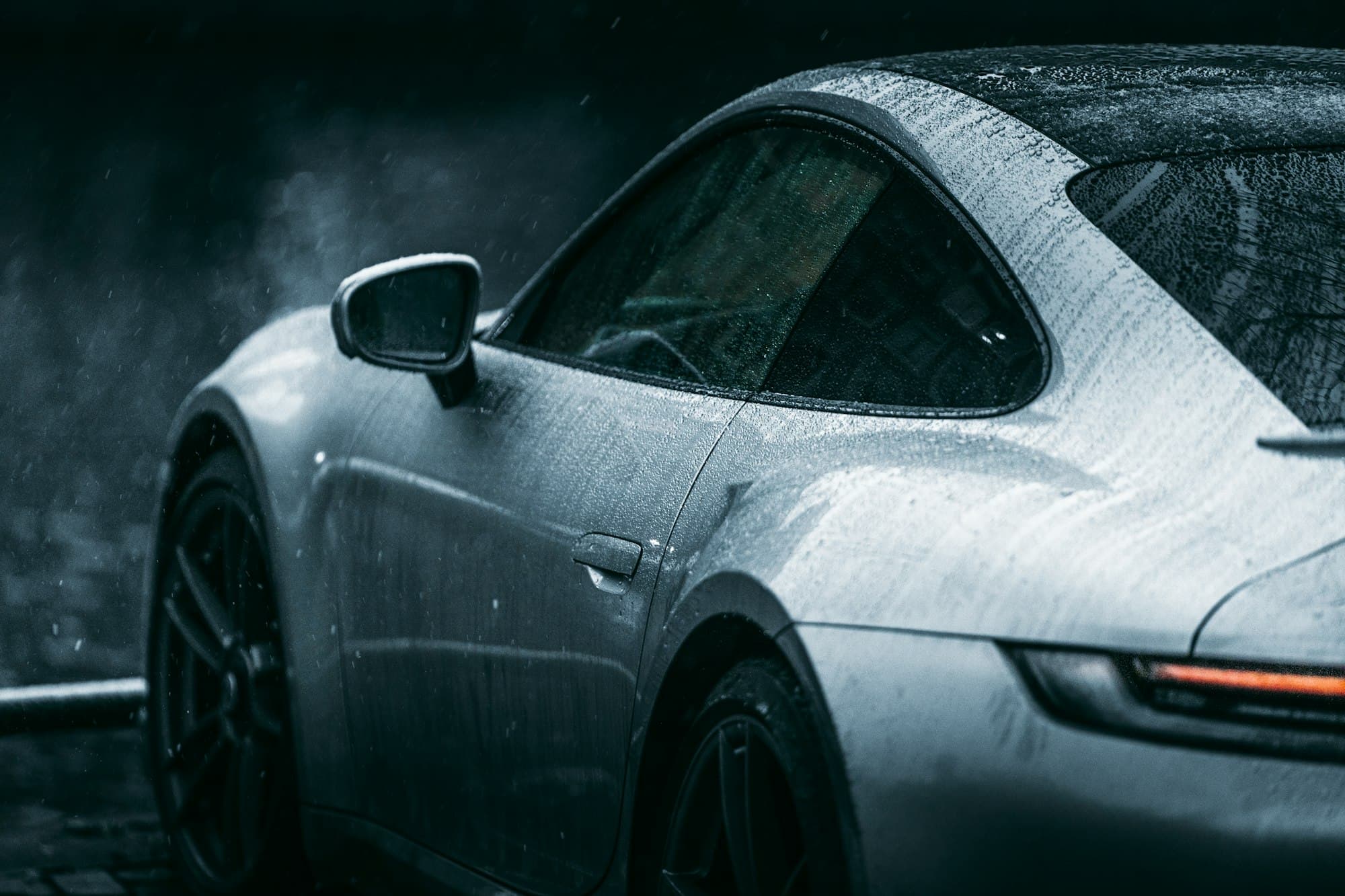 Silver Porsche with water droplets on its paint