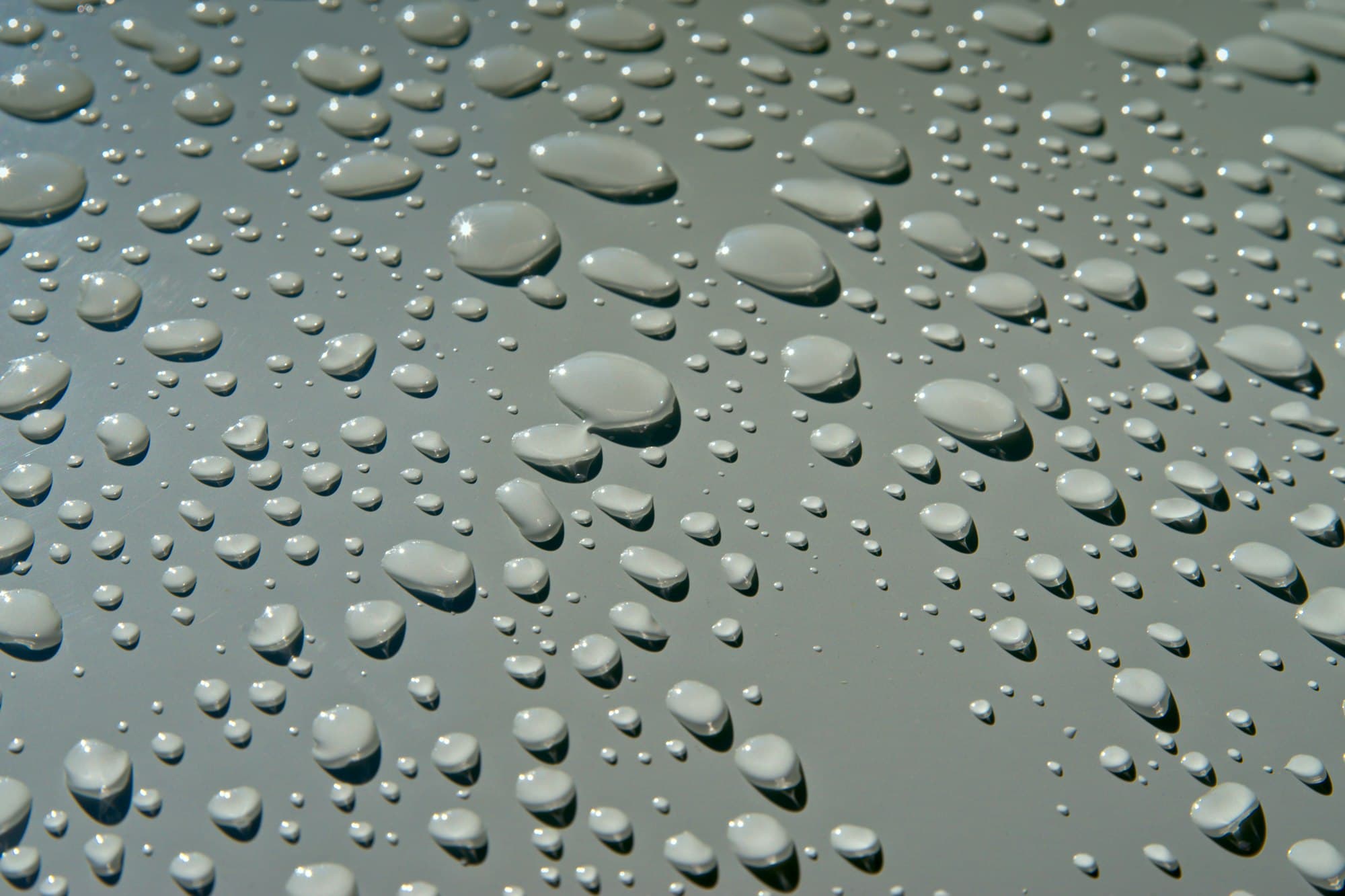 Water droplets beading on coated silver paint