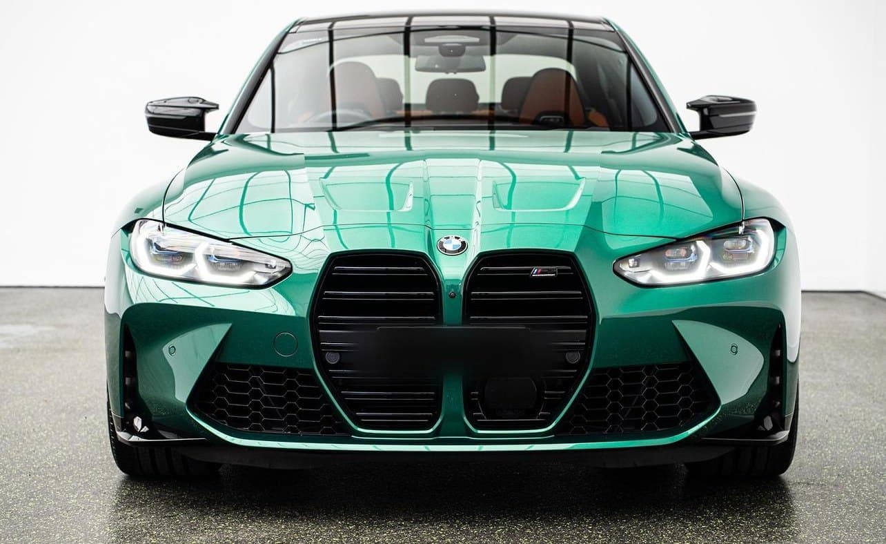 Front of a green BMW M3 in a photo studio